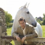 Bladen jacket model posing with white horse